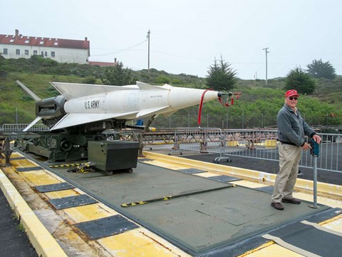 A volunteer demonstrates how a Nike missile rises from storage below ground.