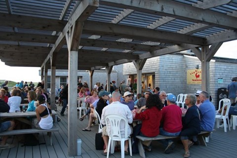 Visitors enjoy food at the snack shack on a summer day.