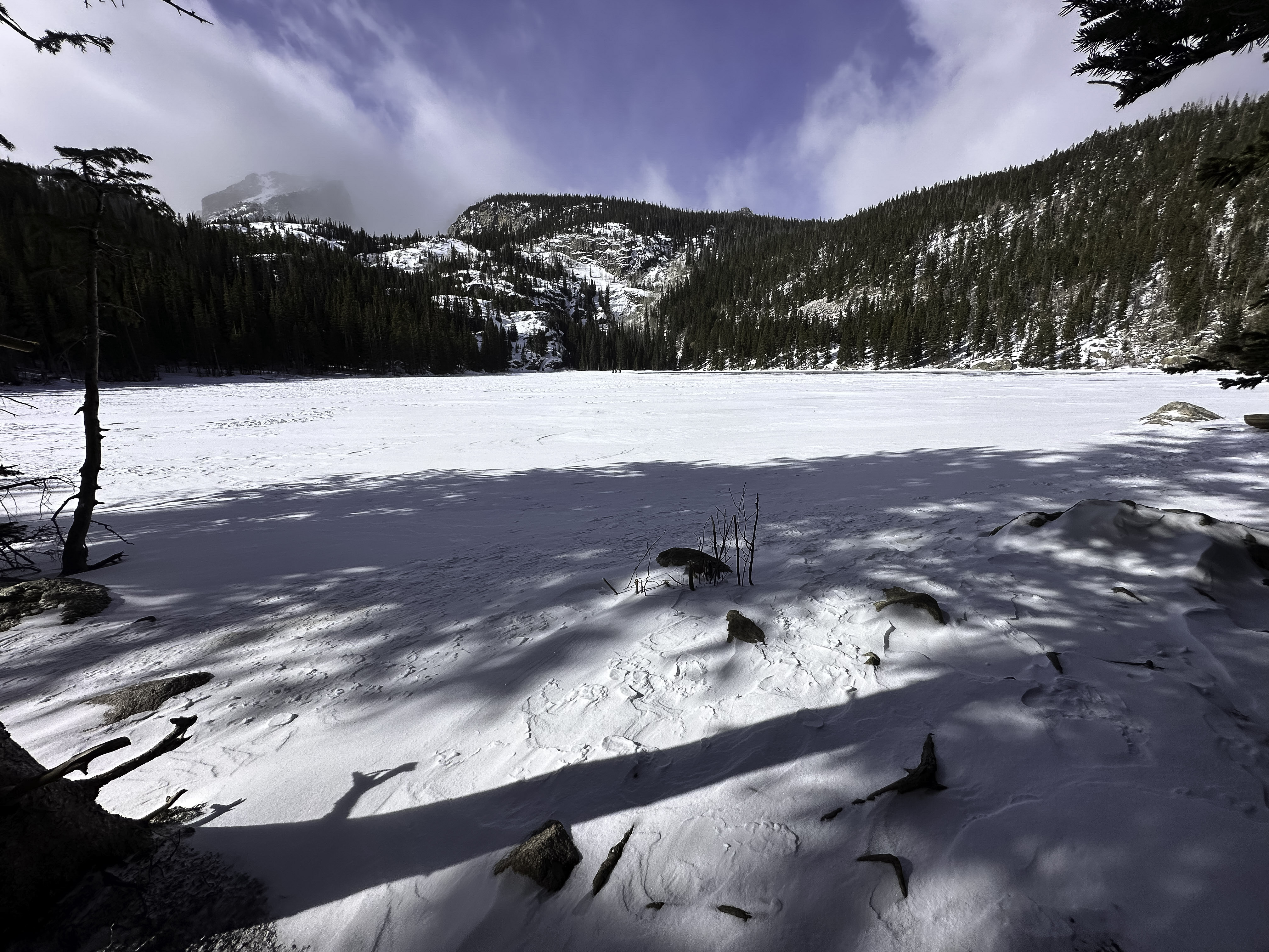 Bear Lake, the surface of the lake is frozen and covered with snow on a sunny day