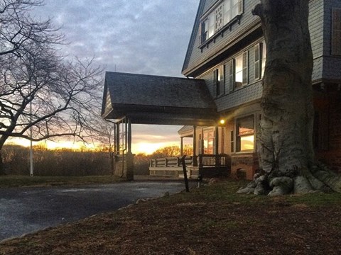 A brilliant sunset, reflecting off the front windows of Theodore Roosevelt's home at Sagamore Hill.