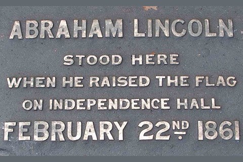Plaque with words "Abraham Lincoln stood here when he raised the flag over Independence Hall."