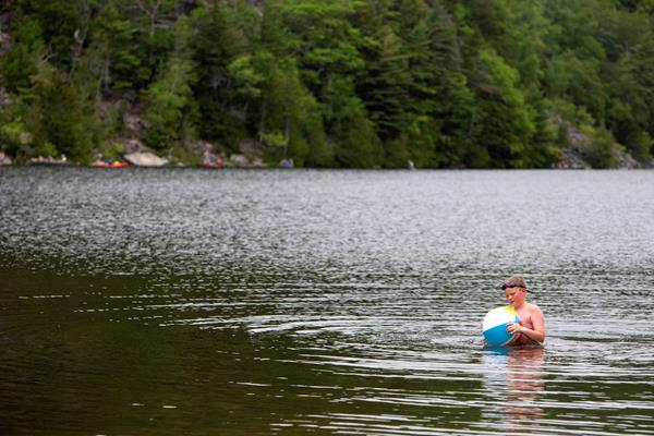 Child with an inflatable toy in a lake