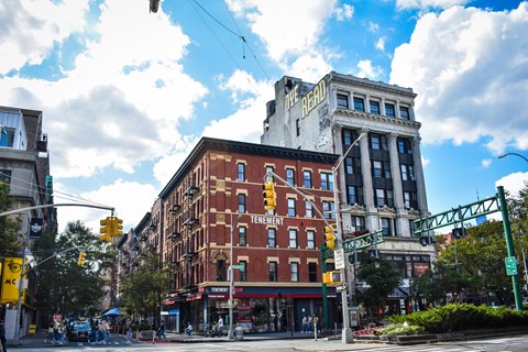 A red brick building against a blue sky with white clouds