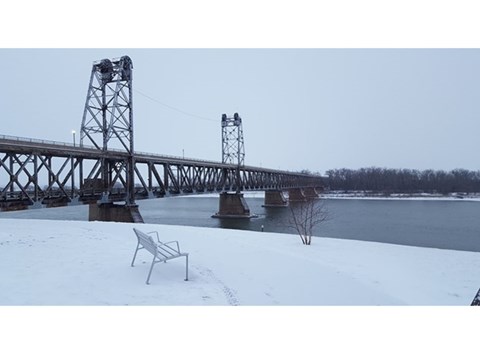 Yankton Double Decker Meridian Bridge over Missouri River. Snow on the ground and covering the bench