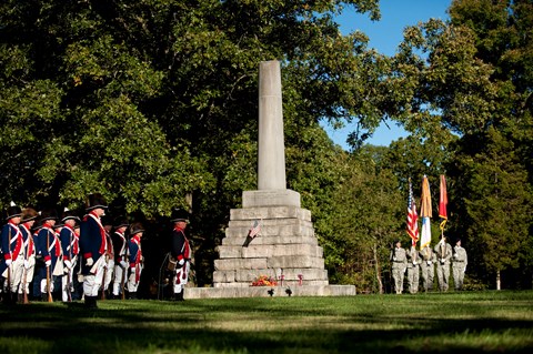 Ceremony honoring the life of Meriwether Lewis with reenactors and Army soldiers.