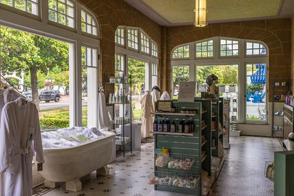 Large rounded windows behind display cases of souvenirs