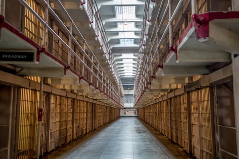 A open hall extended between 2 rows & 3 tiers of cells. Skylights let in light overhead.
