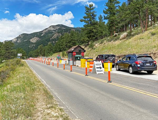 vehicles are lined up to enter the temporary Fall River Entrance under construction