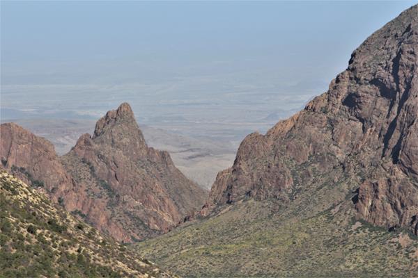 A view through a "V" in the mountains affords views of the desert many miles away.