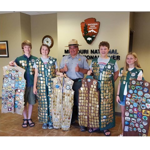 Four junior rangers with the vests and badges.