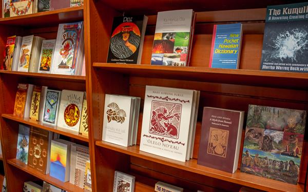 A bookshelf lined with books about Hawaii