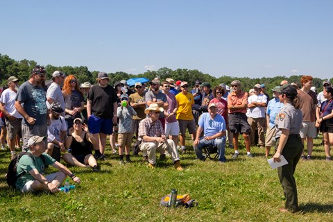 A park ranger gives a program to a group of people.