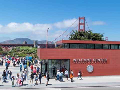 The red brick welcome center, surrounded by visitors at the Golden Gate Bridge