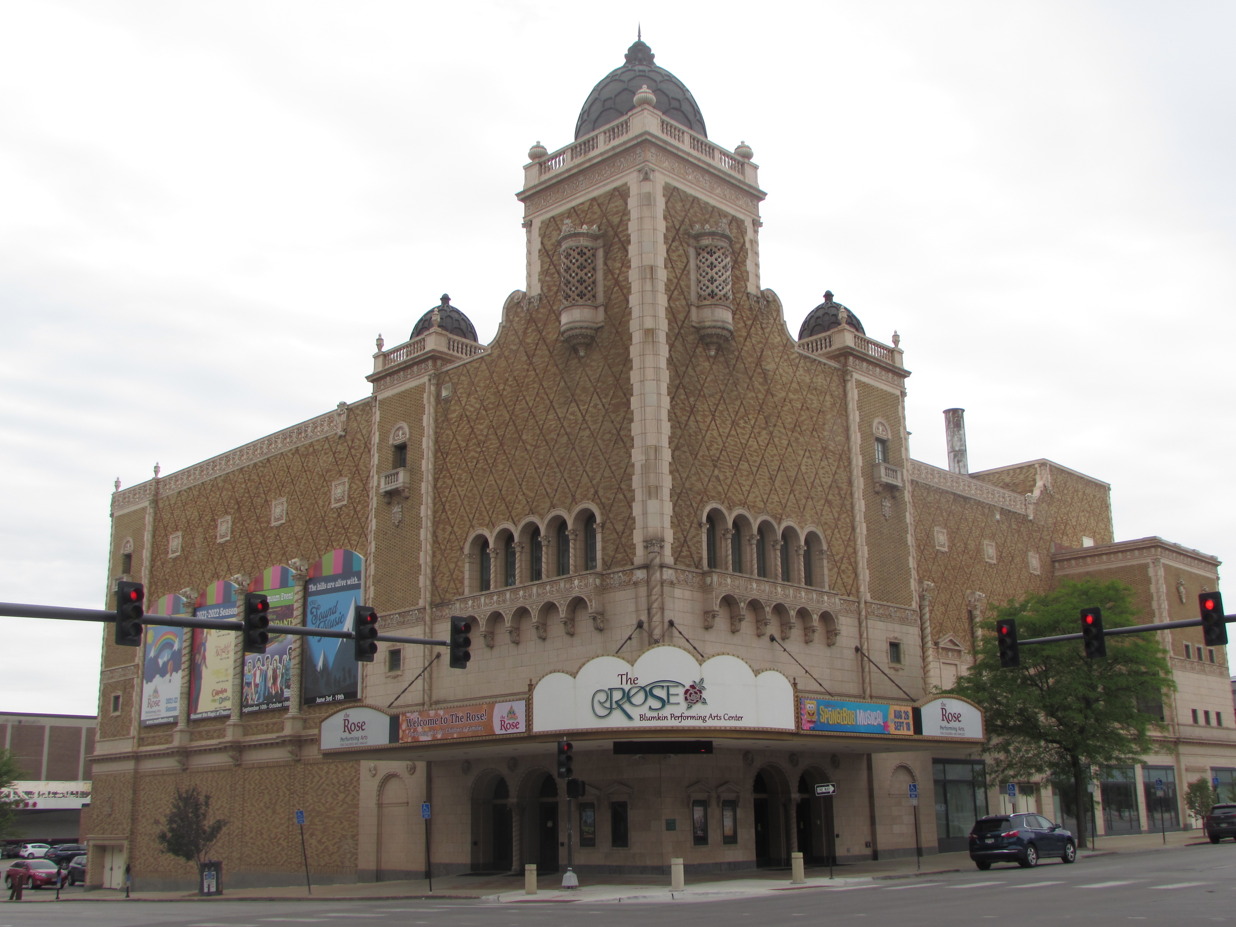 Corner theater building with large Moorish tower. Entrance located at corner of building.