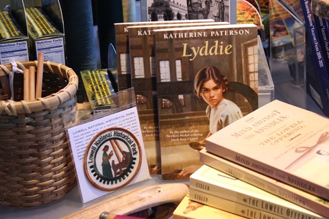 A variety of items, including books and patches, at a gift shop