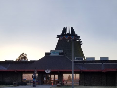 Color photo of a building that resembles a traditional Native American teepee, but far larger.