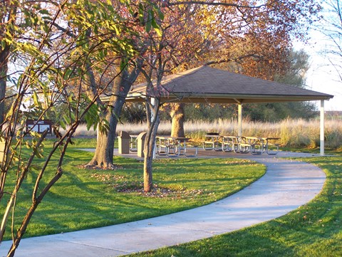 Picnic shelter surrounded by trees and grass
