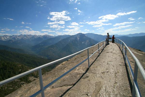 People stand along the narrow ridge of Moro Rock, surrounded by railing. Photo Paul Johnson