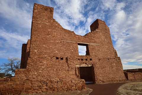 Red sandstone church ruins agains a cloud dotted sky