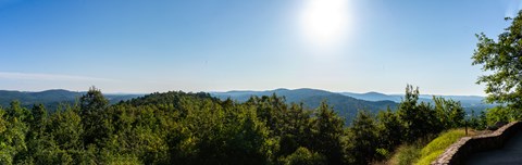 Rolling hills and forested hillsides extend towards the horizon.