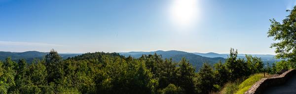 Rolling hills and forested hillsides extend towards the horizon.