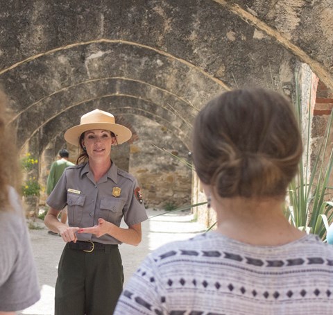 Park Ranger leads a family through the convento at Mission San Jose