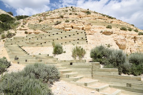 Several switchbacks of stairs lead up along the distinctive rock layers