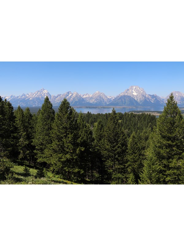 A mountain range and a lake as viewed from a high vantage point.