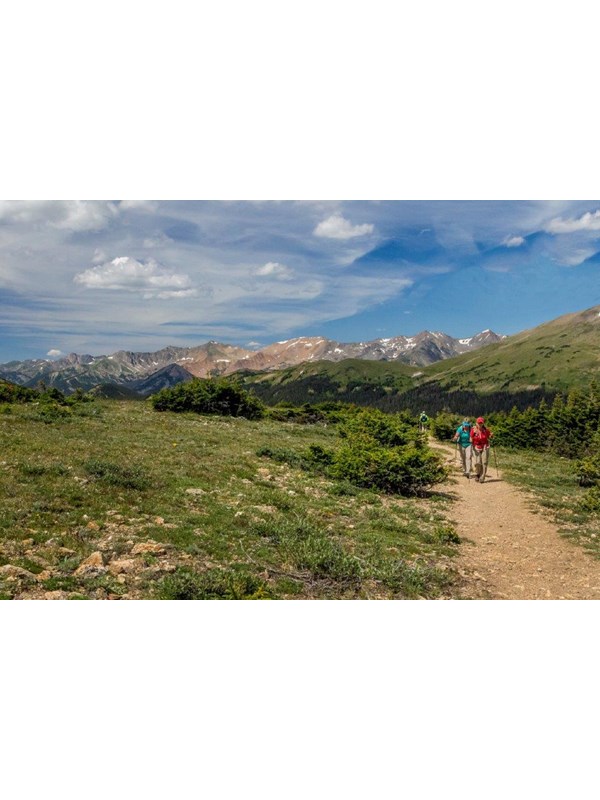 two people hike along a trail