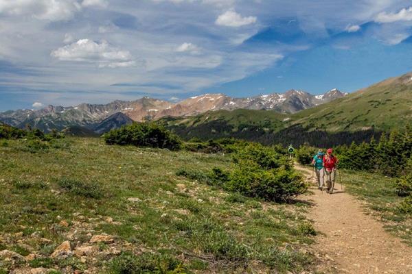 two people hike along a trail