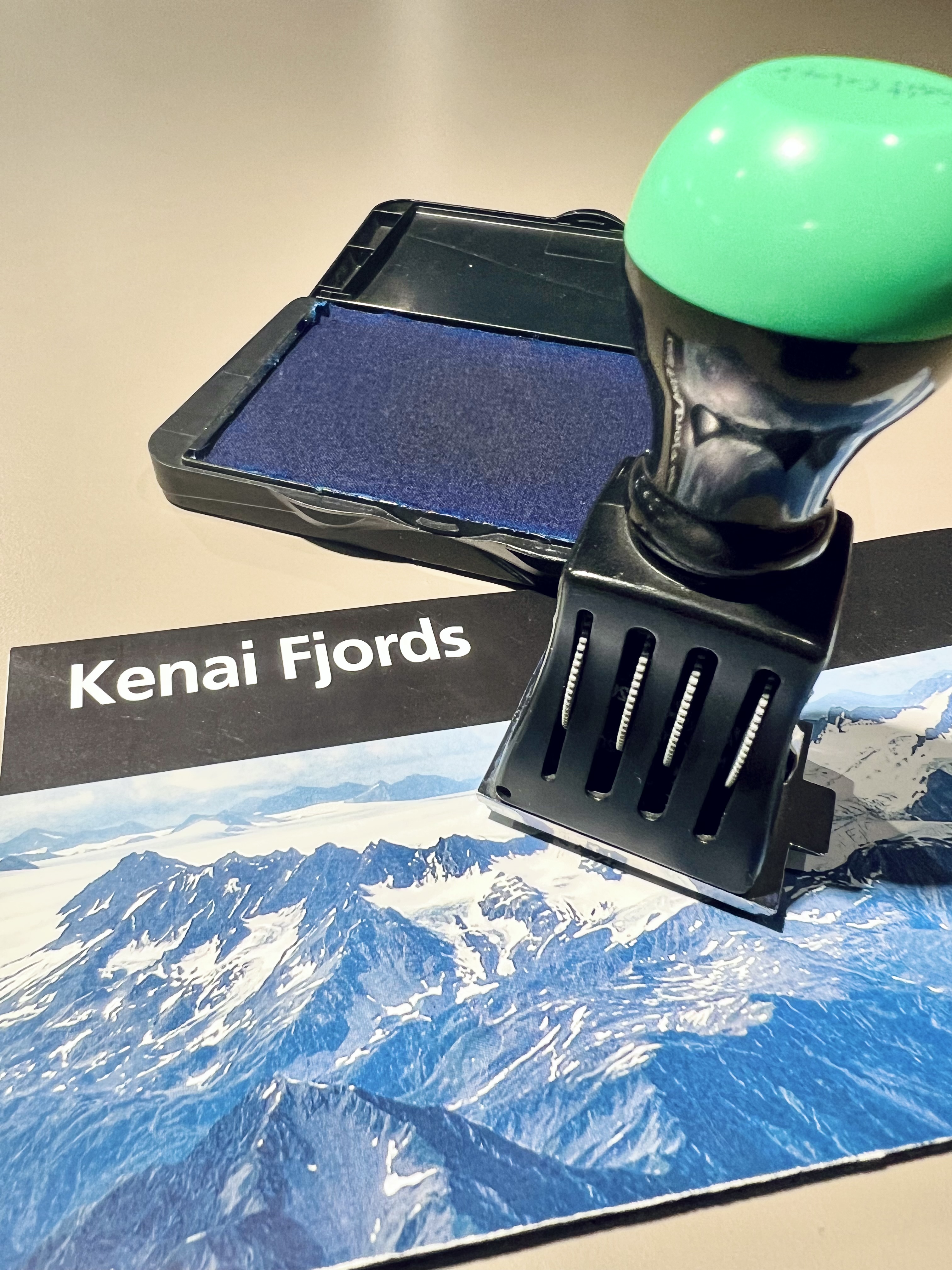 A park cancellation stamp on top of Kenai Fjords brochure