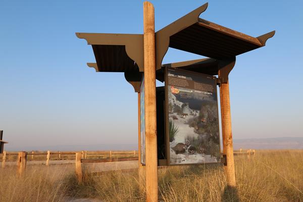 The "Living on the Edge" kiosk panel at sunset.
