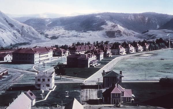 A historic photo of a collection of buildings that make up Fort Yellowstone.