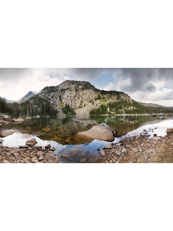 a lake with a large mountain behind it
