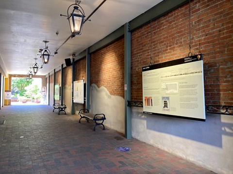 historic carraigeway, gas lamps hang above and educational waysides line the walls.