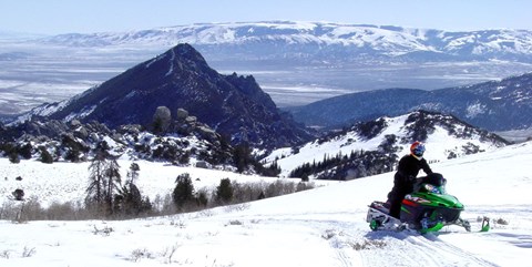 Person riding a snowmobile in the City of Rocks.