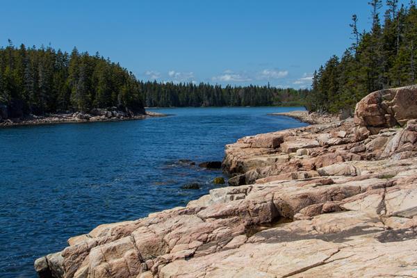 Small harbor with rugged cliffs around edge