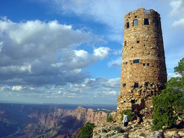 A circular stone tower, 70 feet tall perched on the edge of a vast canyon