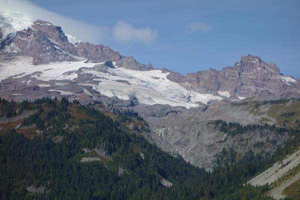 Large waterfall with glacier above it
