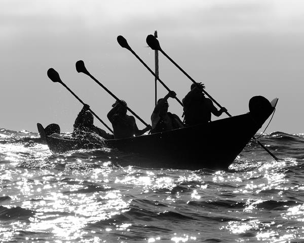 Chumash paddling a canoe shaped boat