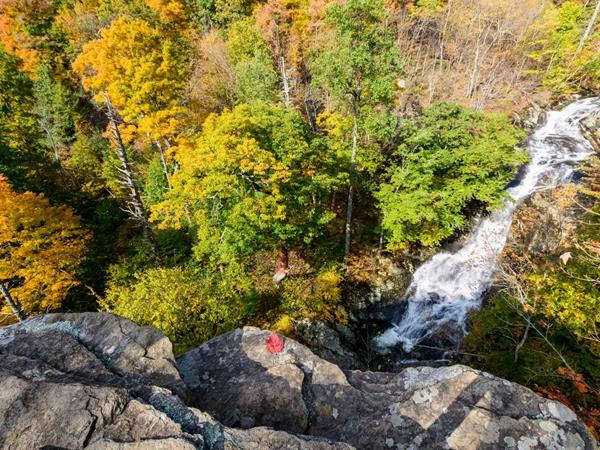A color photograph of swift cascades from atop a rocky outcrop.