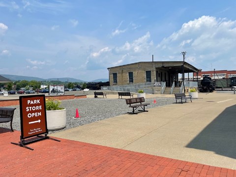 Exterior view of park store building with directional sign pointing visitors to store