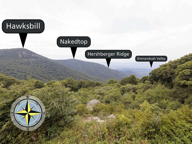 View over field with ridge descending to valley.