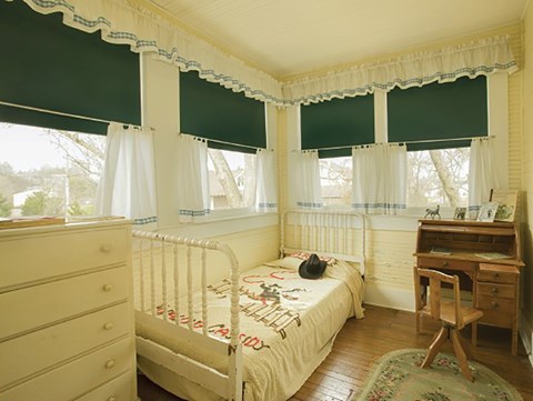 Young Bill Clinton's bedroom includes a replica rolltop desk, bed with Hopalong Cassidy blanket and