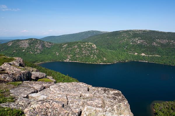 View from cliffs of forest and pond below