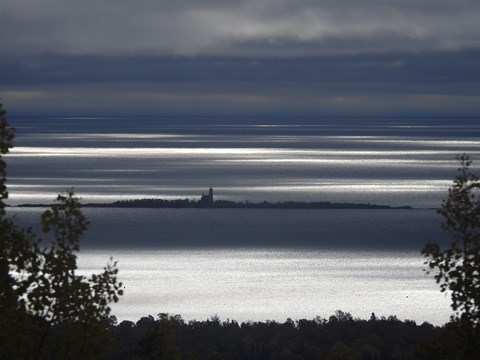 View of Lake, island, and lighthouse in the distance.