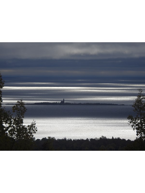 View of Lake, island, and lighthouse in the distance.