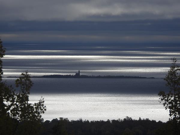 View of Lake, island, and lighthouse in the distance.