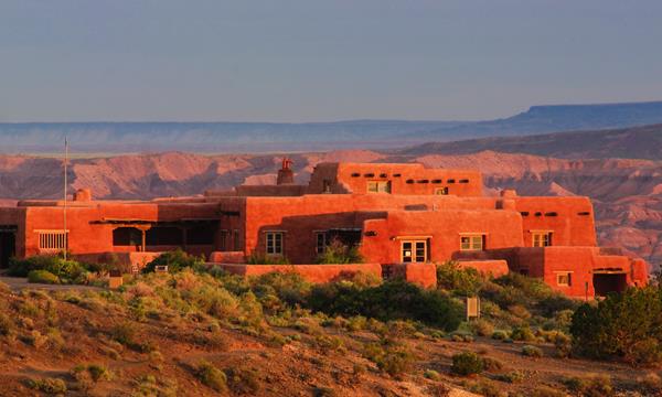 Historic Pueblo-Revival style building sitting on the edge of a mesa above the Painted Desert
