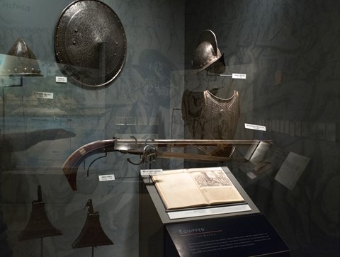 a glass display case with french armor